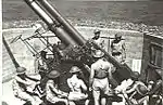 Gunners working on 3.7-inch (94 mm) heavy anti-aircraft gun. 1943.
