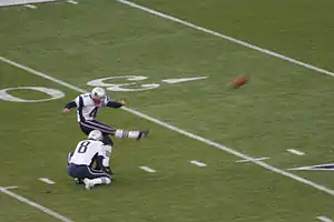 Adam Vinatieri warms up before the game