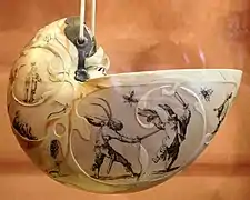 Nautilus shell carved and painted with fanciful scenes of human figures and animals