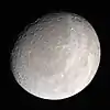 Cassini color image of Rhea - large crater Powehiwehi (right center) - chasmata stretch vertically above (past crater Wakonda, near the terminator) - Onokoro Catenae (lower left).