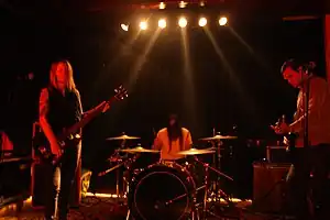 True Widow, performing live in Berlin in 2010, from left to right:  Nicole Estill, Timothy Starks and Dan Phillips